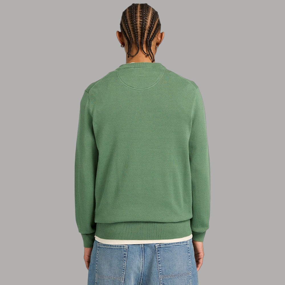 Maglia girocollo verde, retro liscio, maniche lunghe e costine a polsini e fondo