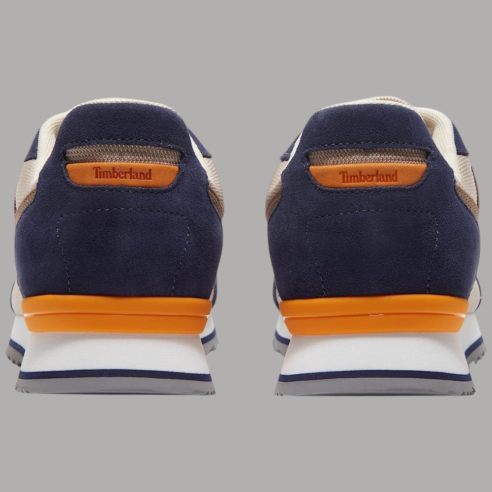 Sneaker Timberland con tallone blu scuro, inserti beige e suola bianca con arancione