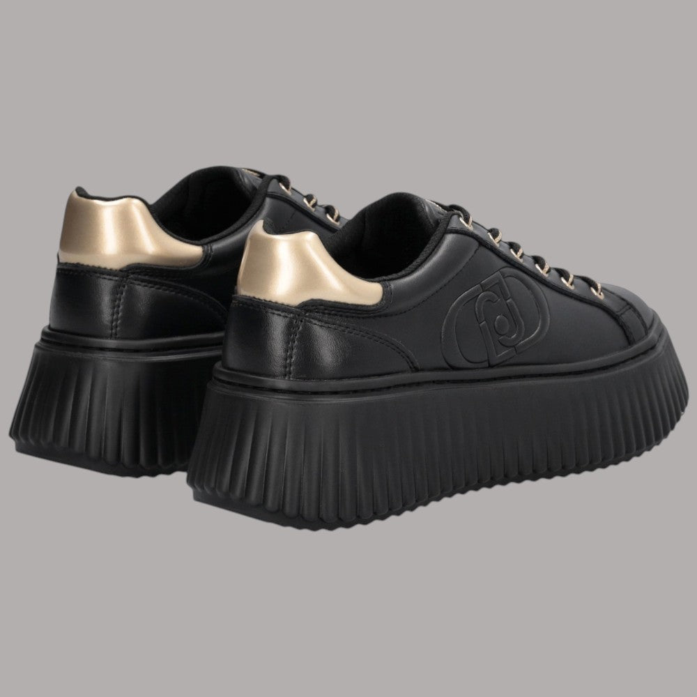 Sneaker nere con talloni dorati e suola platform strutturata
