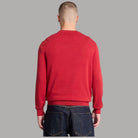 Maglione Timberland rosso visto da dietro, con maniche lunghe e orlo a costine