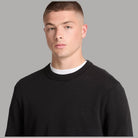 Maglione Timberland nero in cotone biologico, dettaglio del girocollo e del logo ricamato