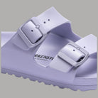 Ciabatte Birkenstock Arizona Eva viola chiaro, dettaglio tomaia con due fibbie e logo.