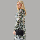 Mini tracolla nera con catena dorata e logo Guess, portata a tracolla