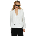 Blusa bianca con scollo a V e maniche lunghe con frange