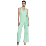 Tuta elegante verde con scollo a V, spalline larghe e pantaloni a gamba ampia