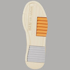 Suola sneakers in beige con inserti arancioni e battistrada a righe