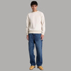 Felpa Timberland girocollo color avorio, vista frontale a figura intera con polsini e fondo a coste