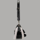 Mini borsa a spalla nera con tracolla regolabile e inserti teddy chiari, zip